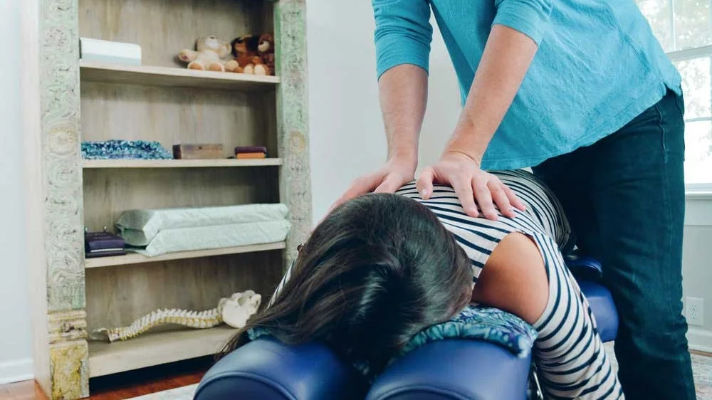 A patient receiving personalized chiropractic care at Hands of Hope